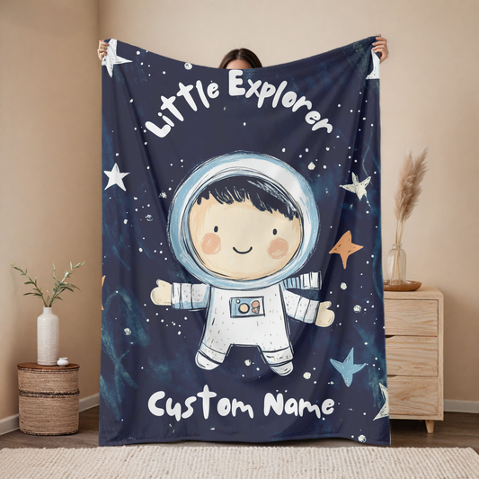 Personalized astronaut baby blanket with custom name, navy space design featuring cute explorer and stars, nursery decor mockup