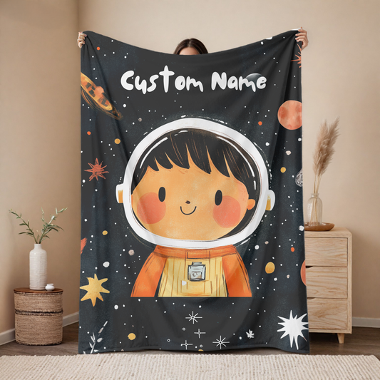 Personalized astronaut baby blanket with custom name, midnight galaxy portrait design on dark starry background with planets, nursery decor mockup