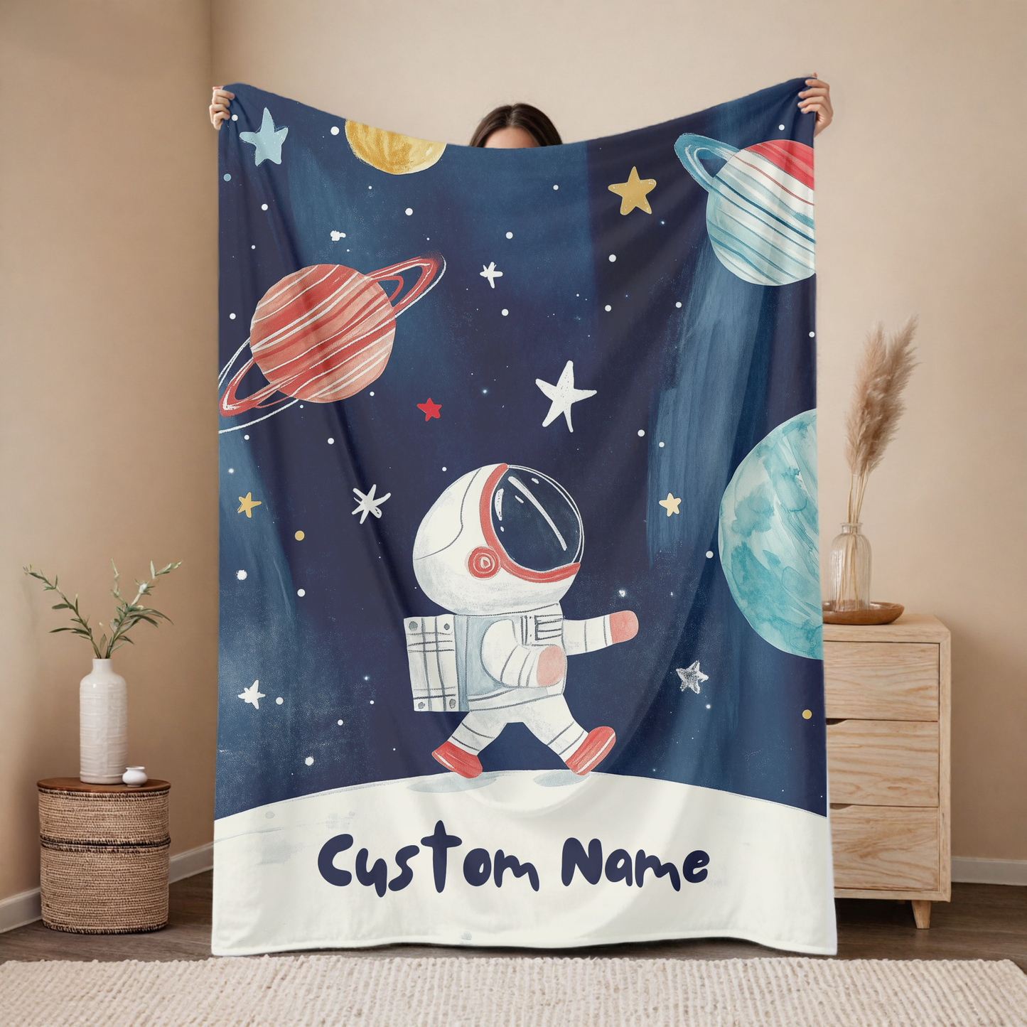 Personalized astronaut baby blanket with custom name, space walk galaxy design featuring planets and stars on navy background, nursery decor mockup