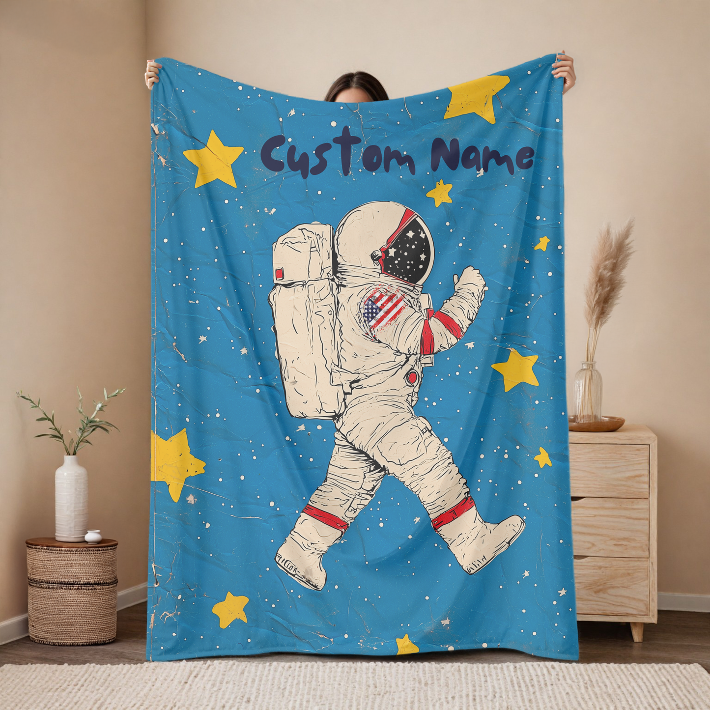 Personalized astronaut baby blanket with custom name, vintage space walker design on blue background with yellow stars, nursery decor mockup