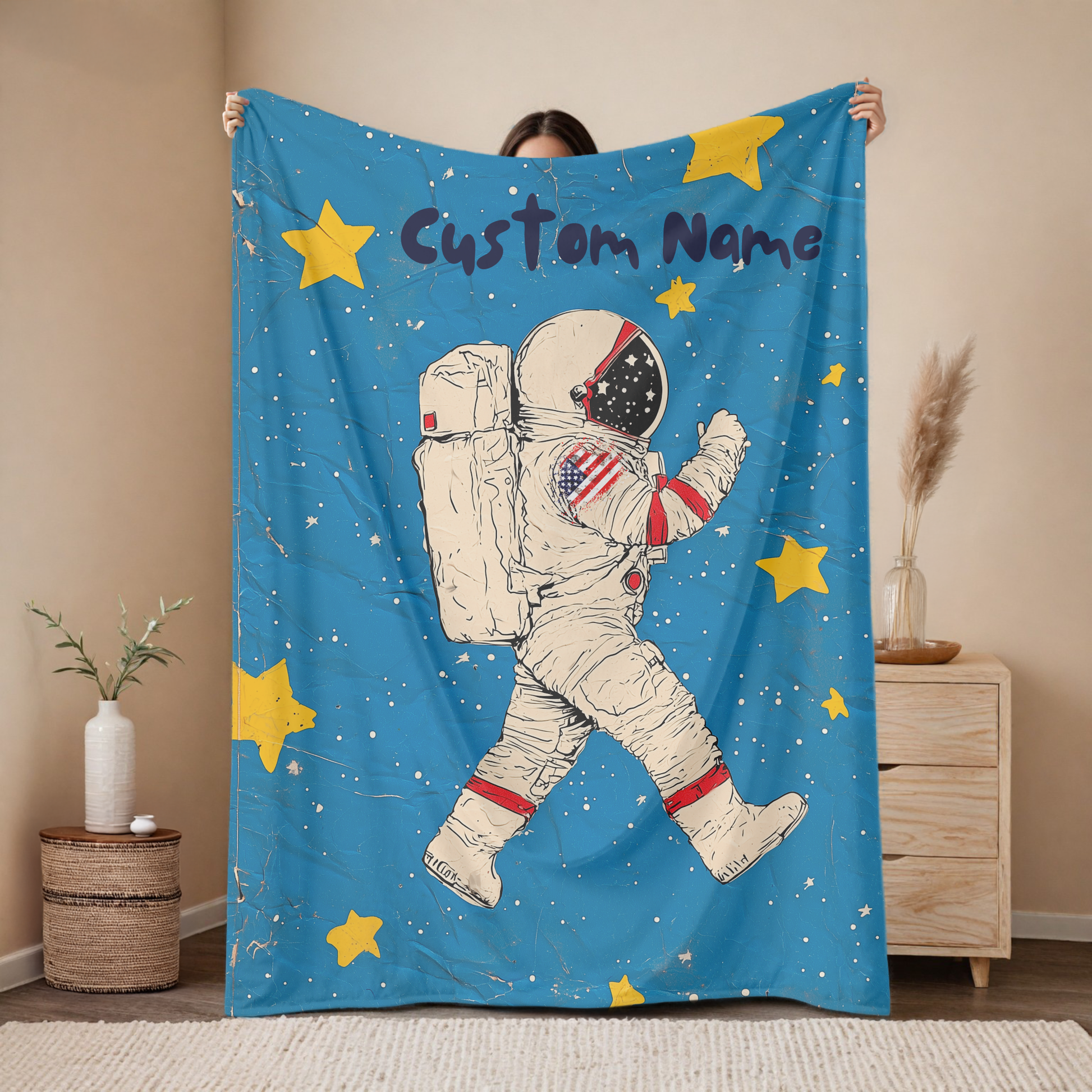 Personalized astronaut baby blanket with custom name, vintage space walker design on blue background with yellow stars, nursery decor mockup