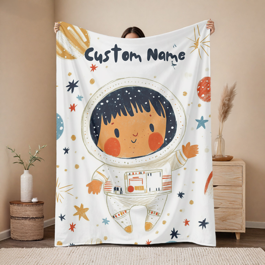 Personalized astronaut baby blanket with custom name, warm galaxy explorer design on light background with colorful stars and planets, nursery decor mockup