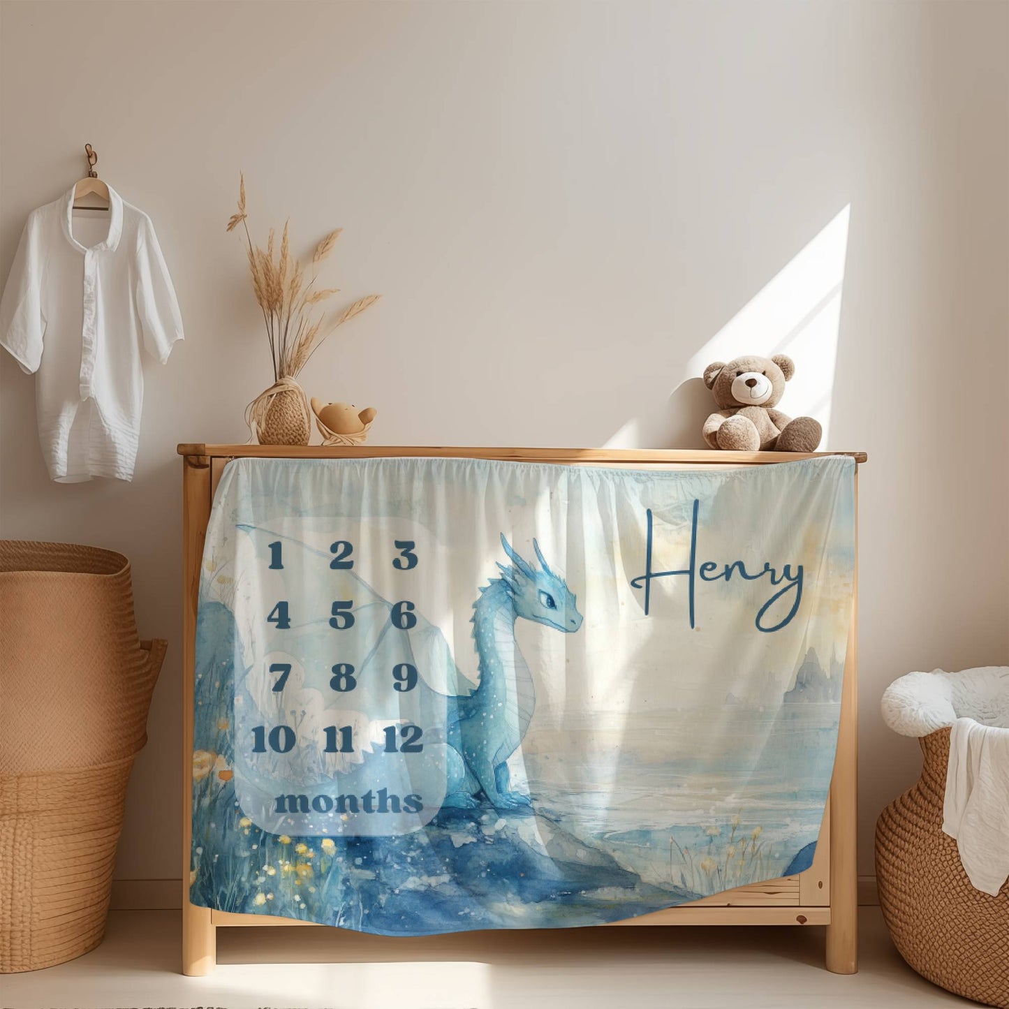 Personalized baby milestone blanket with blue dragon illustration for monthly baby photos in nursery