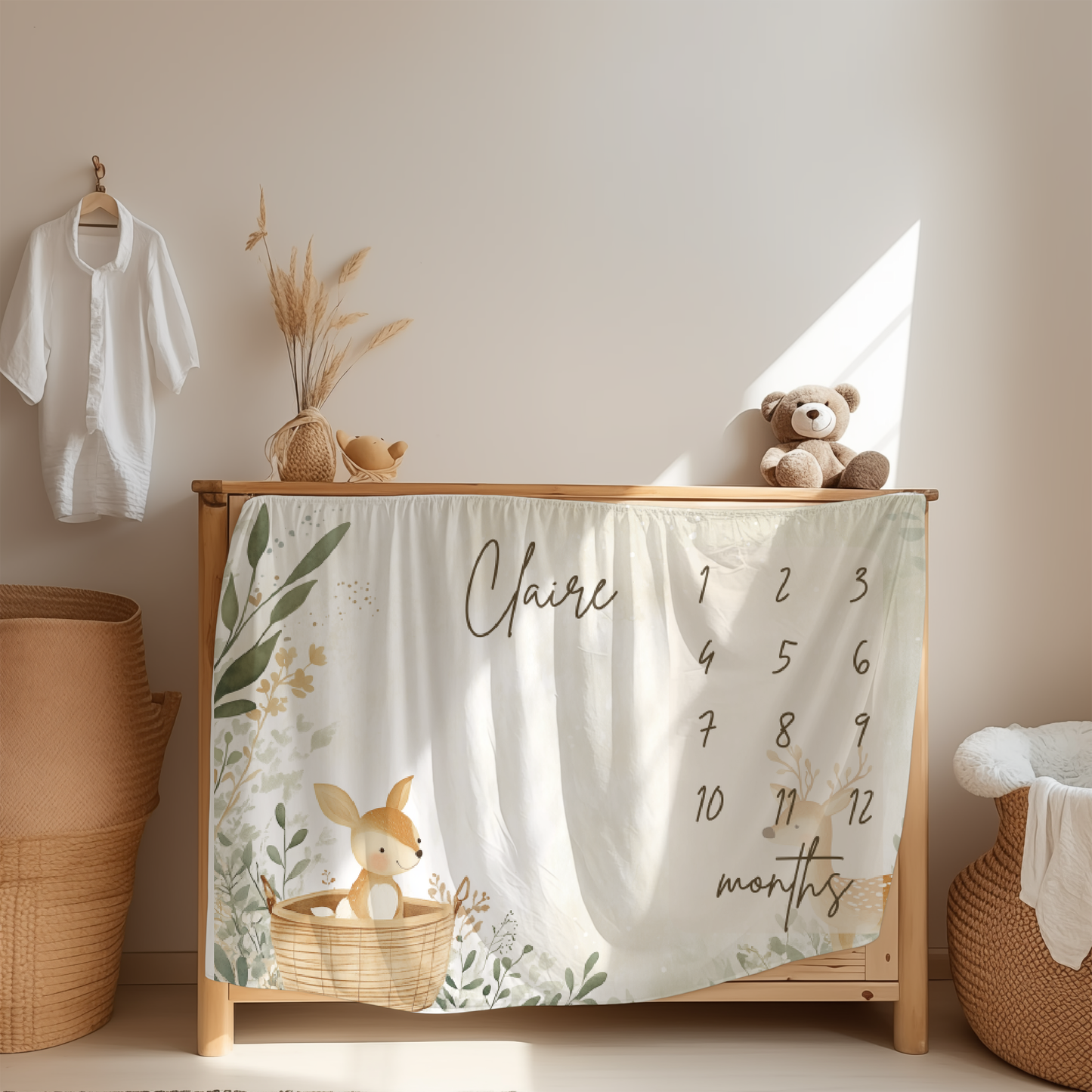 Personalized baby milestone blanket with boho deer garden design displayed in a cozy nursery room