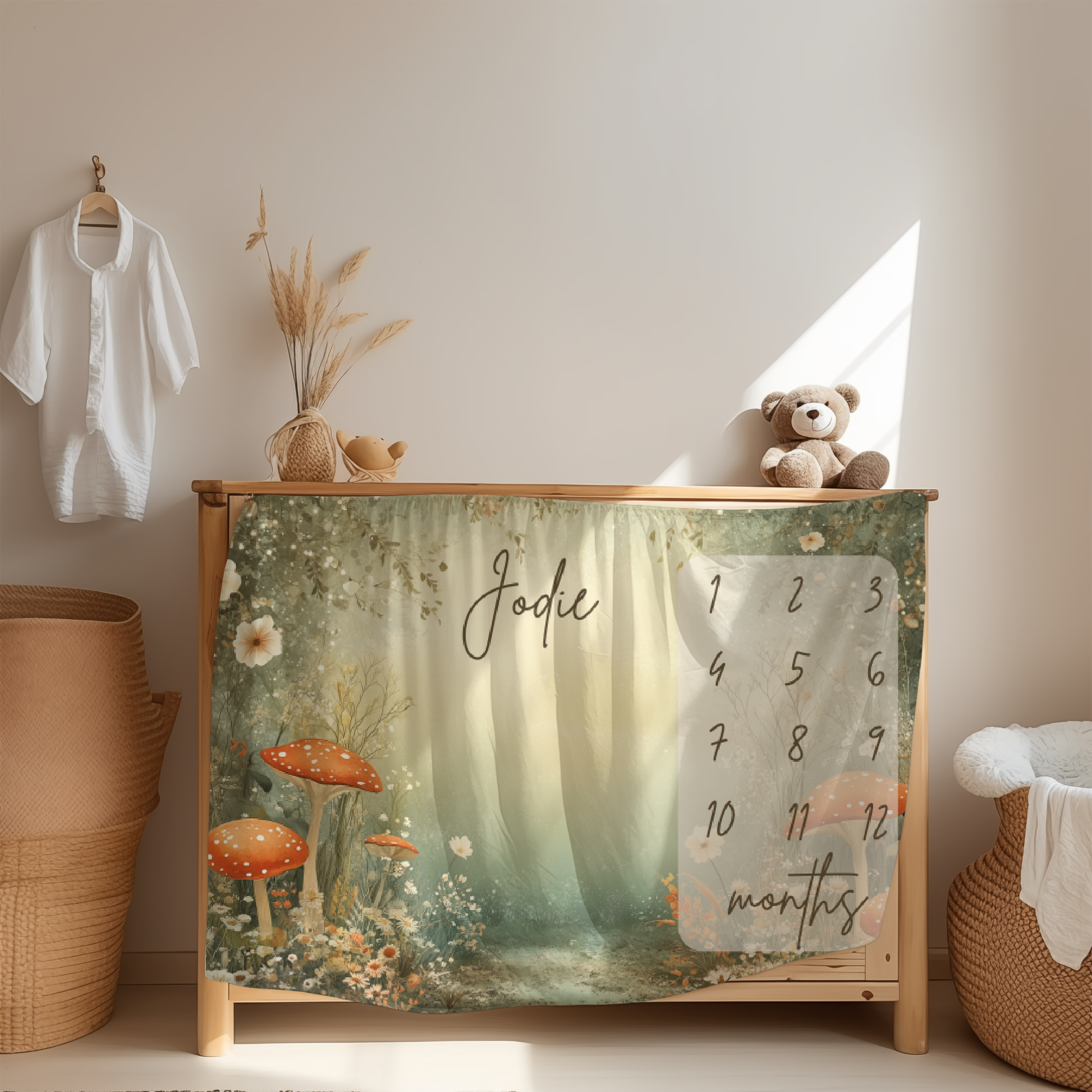 Personalized baby milestone blanket with enchanted forest mushrooms design displayed in nursery room