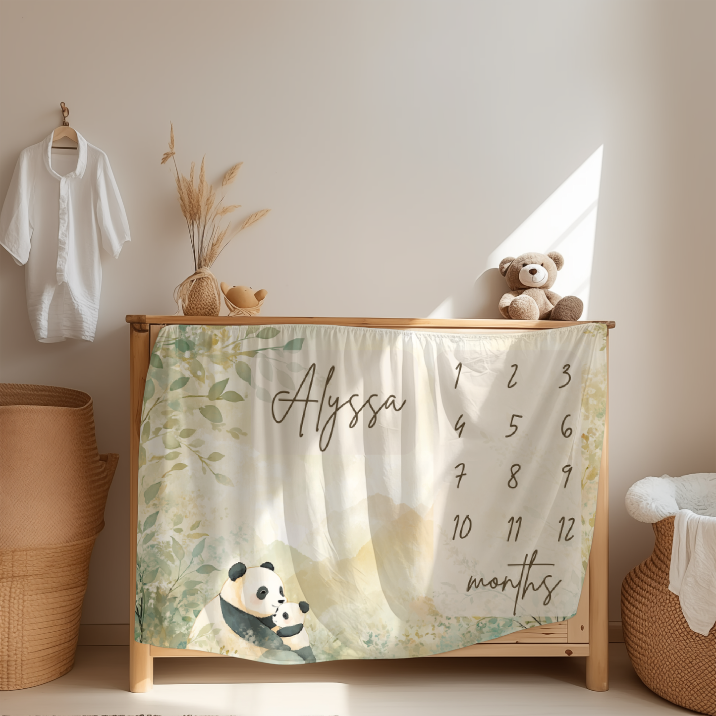 Personalized baby milestone blanket with panda and soft mountain landscape design displayed in nursery room
