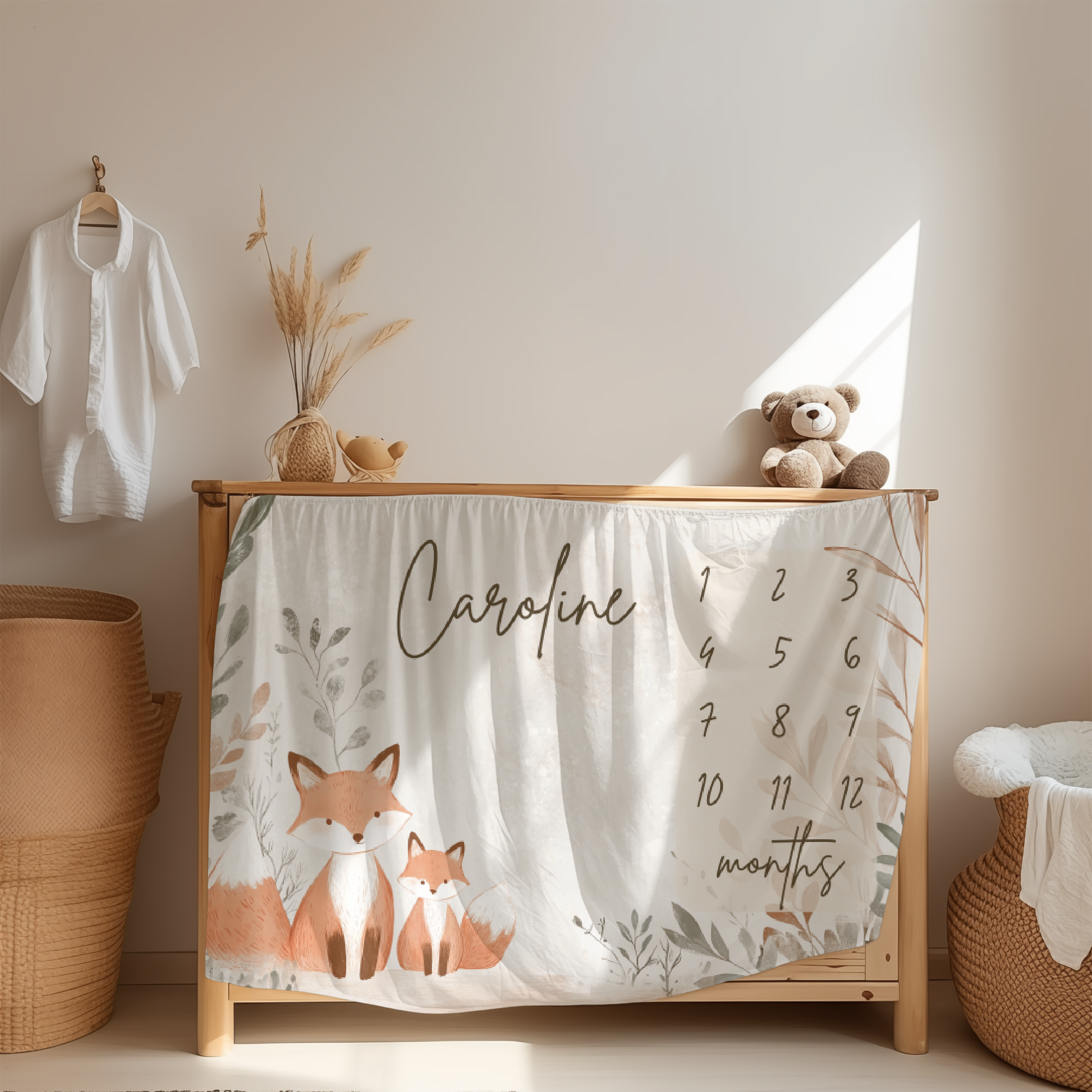 Personalized baby milestone blanket with woodland fox illustration displayed in nursery room