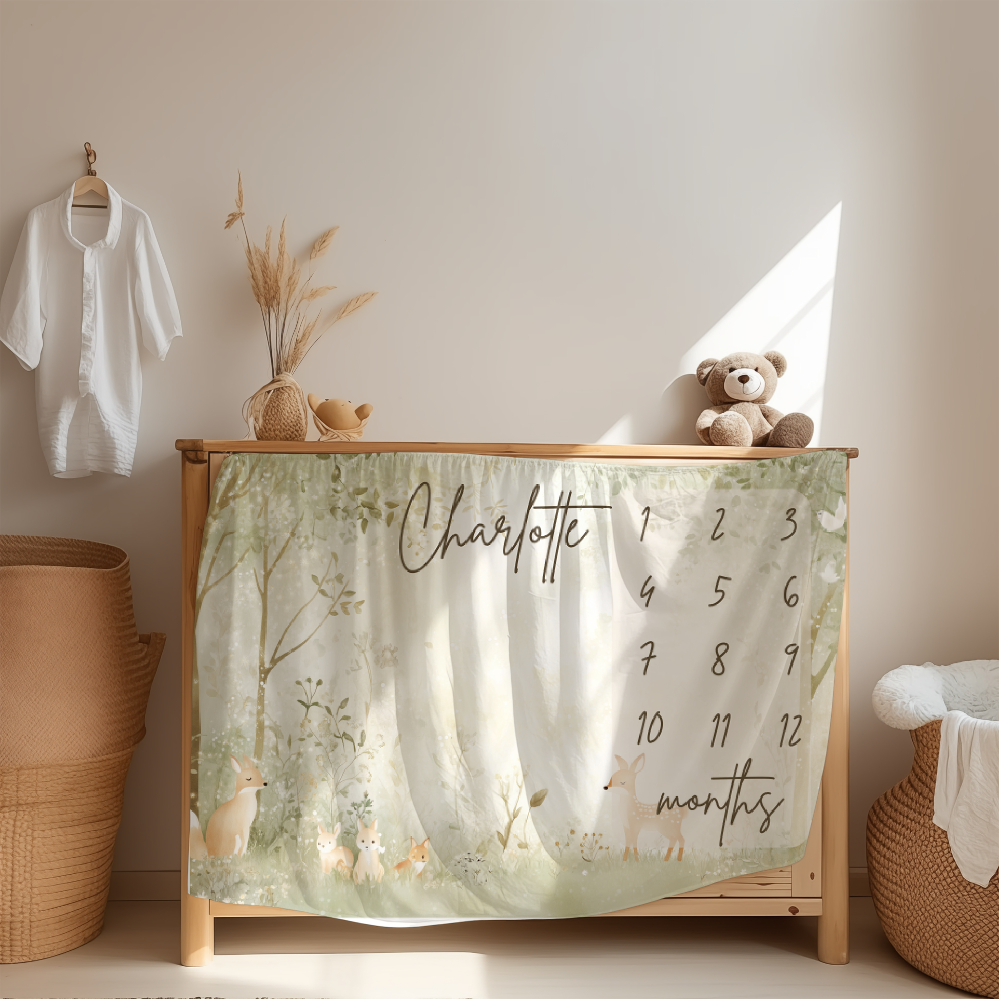 Personalized baby milestone blanket with whimsical woodland animals design displayed in a cozy nursery room