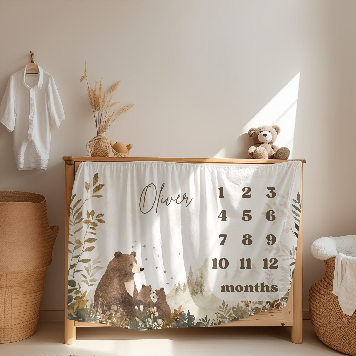 Personalized baby milestone blanket with woodland bear and cubs design displayed in a cozy nursery room