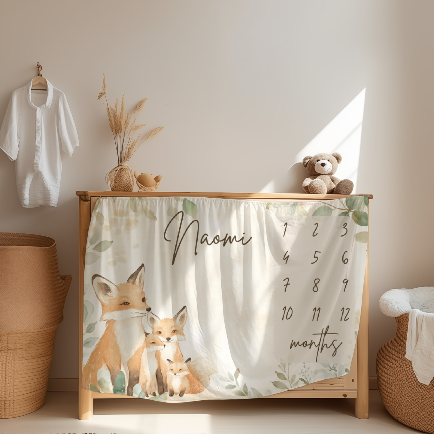 Personalized baby milestone blanket with woodland fox family design displayed in nursery room