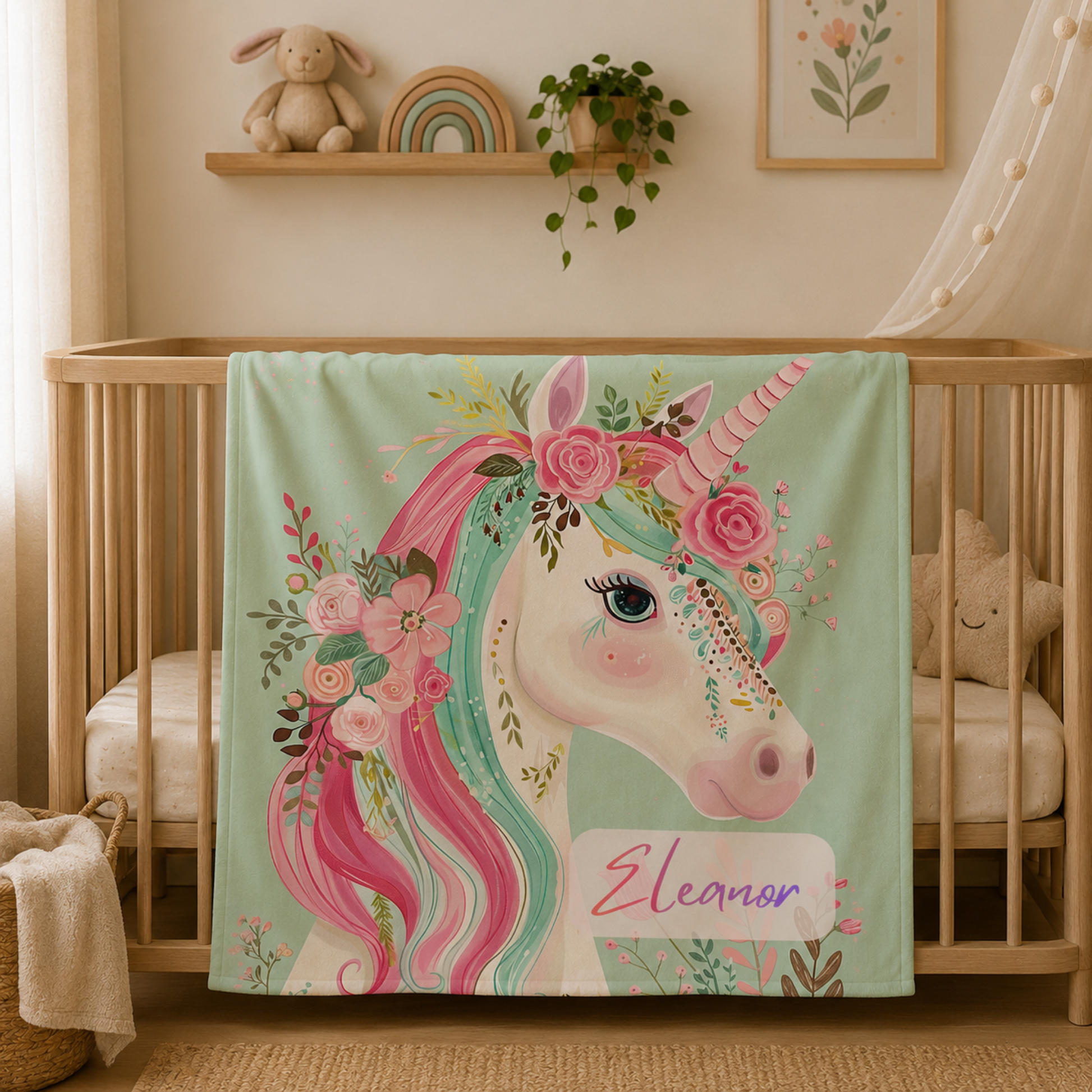 Personalized unicorn baby blanket with custom name draped over crib, rainbow rose portrait design
