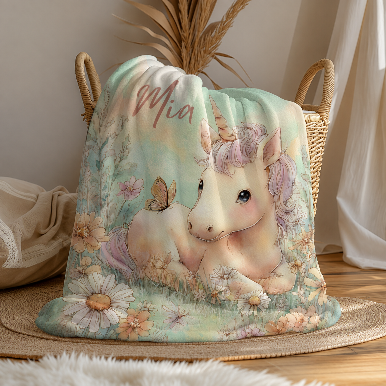 Personalized unicorn baby blanket with custom name draped over basket, wildflower meadow design